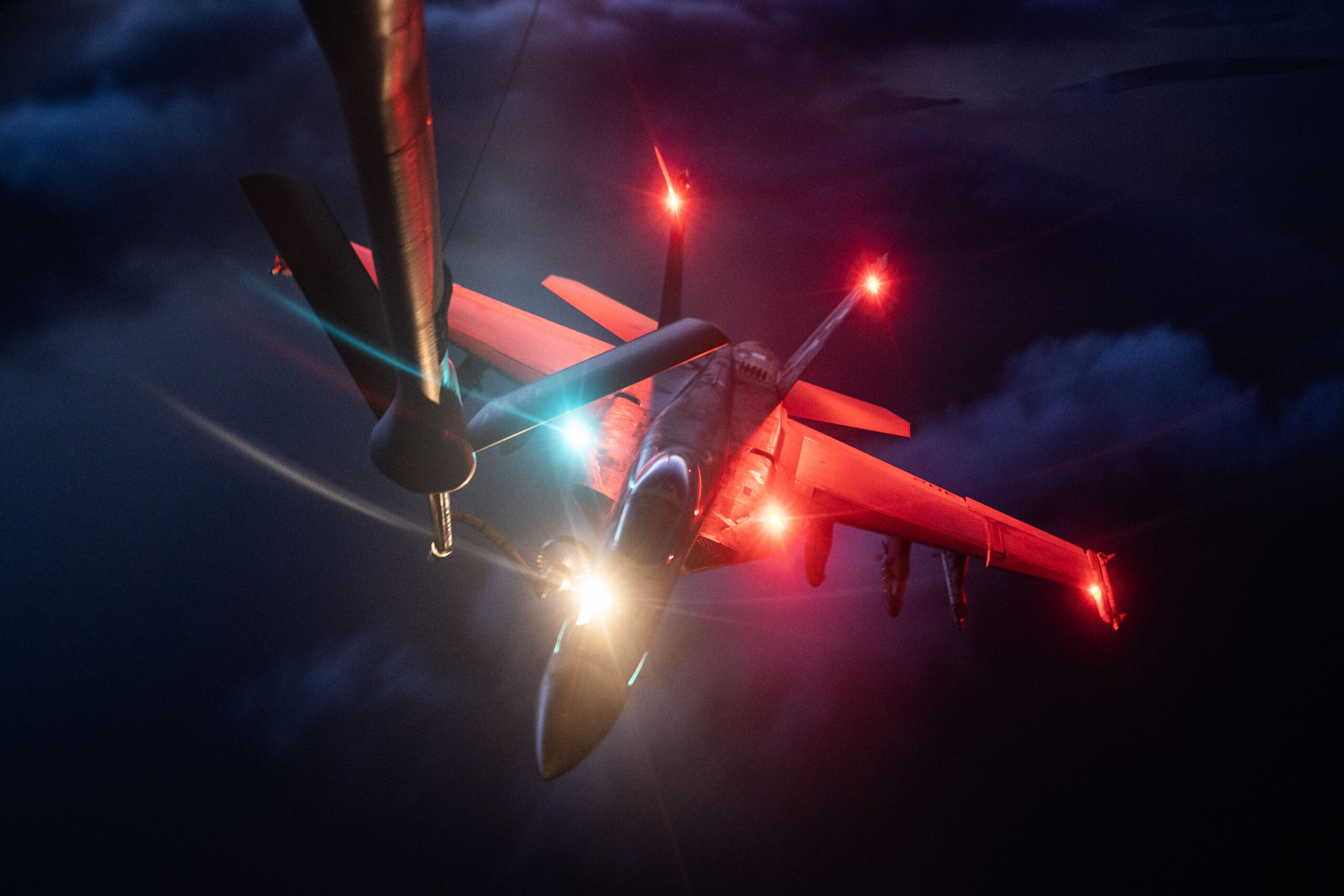 A U.S. Navy F/A-18E Super Hornet receives fuel from a U.S. Air Force KC-135 Stratotanker from Fairchild Air Force Base’s 92nd Air Refueling Squadron over the U.S. Central Command area of responsibility, May 10, 2024. The U.S. Air Force is globally postured to protect and defend freedom of coalition allies and regional partners within the CENTCOM area of responsibility to maintain peace and stability across the region. (U.S. Air Force Photo.)