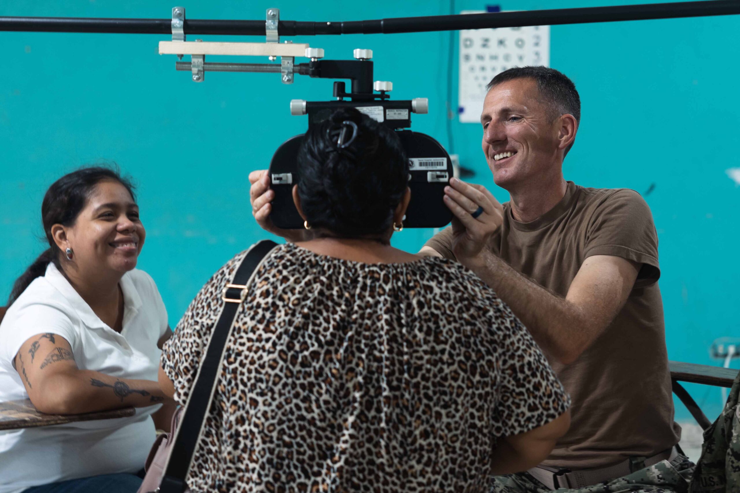 PUERTO CORTÉS, Honduras (July 29, 2024) Cmdr. Brent Collins, right, conducts a vision assessment during a joint medical brigade with Honduran medical professionals during Continuing Promise 2024 in Puerto CortŽs, Honduras. Continuing Promise 2024 marks the 14th mission to the region since 2007, which aims to foster goodwill, strengthen existing partnerships, and encourage the establishment of new partnerships among countries, non-government organizations, and international organizations. (U.S. Navy photo by Mass Communication Specialist Seaman Jasmin L. Aquino.)