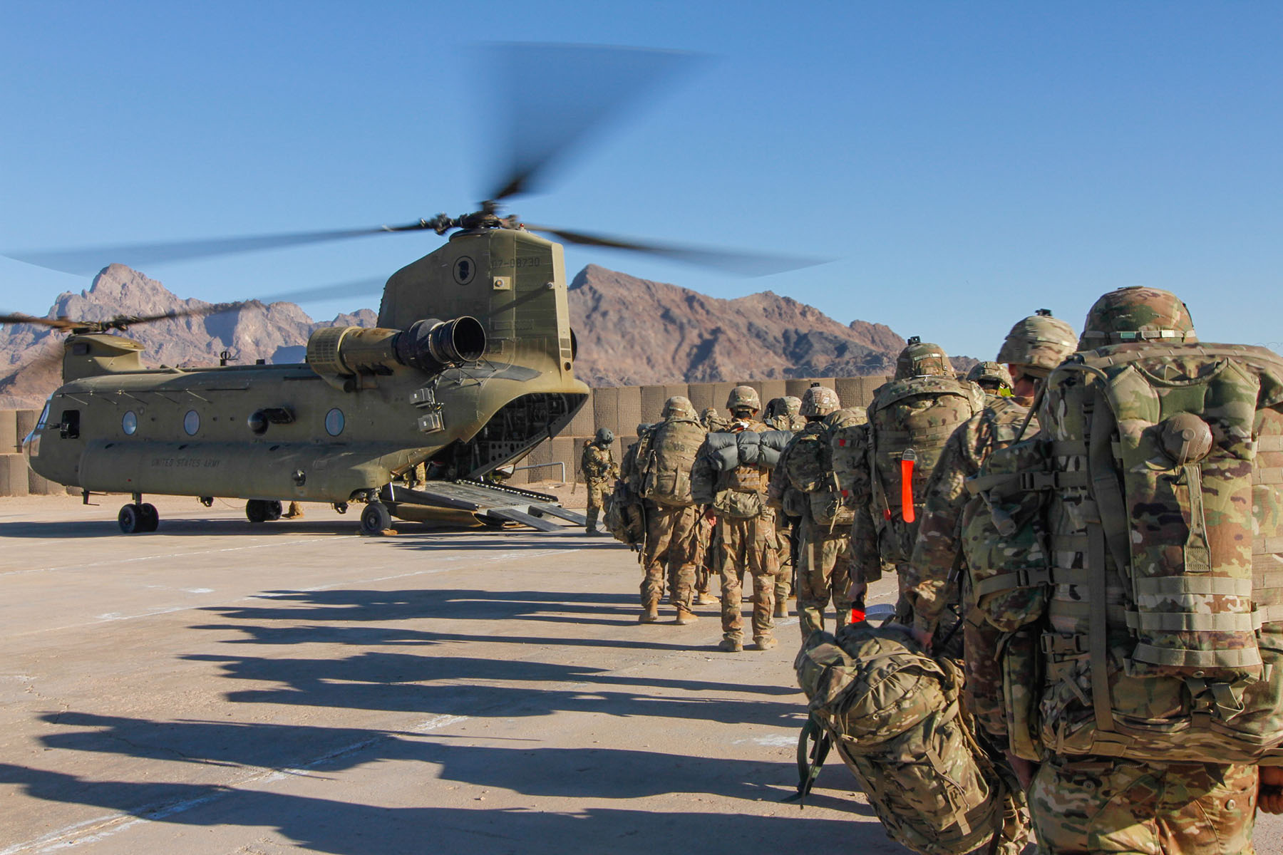 Soldiers attached to the 101st Resolute Support Sustainment Brigade from the 1034th Combat Sustainment Support Battalion, Iowa National Guard and 10th Mountain, 2-14 Infantry Battalion, Ghost Forward Support Company load onto a Chinook helicopter to head out and execute missions across the Combined Joint Operations Area- Afghanistan. (Photo by 1st Lt. Verniccia Ford.)