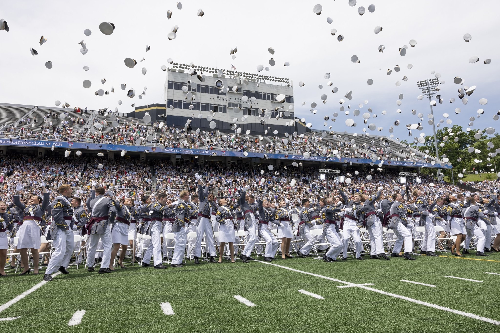 Cadets of the United States Military Academy at West Point throw their hats into the air during the graduation ceremony for the class of 2024 at Michie Stadium. West Point, New York, May 25, 2024. (U.S. Army Photo by Kyle Osterhoudt.)