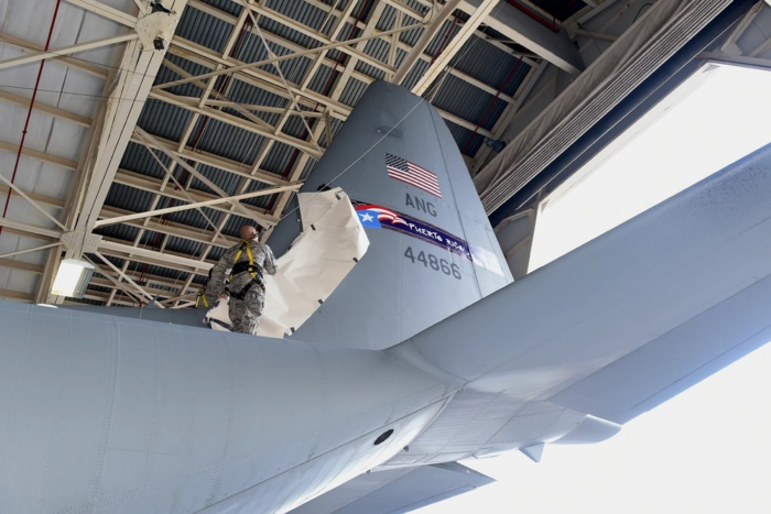 U.S. Air Force airmen unveils the winning tail flash for 156th Airlift Wing, Muñiz Air National Guard Base, Carolina, Puerto Rico, during the WC-130 Tail Flash Unveiling Ceremony in Hangar 1, March 6, 2016. Winning design was designed by Staff Sgt. Luis A. Morales, aircrew flight equipment of the 156th Operation Squadron. (U.S. Air National Guard photo by Tech. Sgt. Efrain Sanchez.)