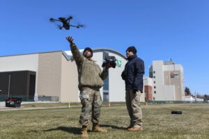 A 319th Security Forces Squadron base defense operations center controller practices a drone landing during an unmanned aircraft system flight training course at the University of North Dakota, Grand Forks, April 27, 2022. Over the course of three days, members familiarized themselves with the drone features that can assist them with conducting daily operations such as security patrol and incident response missions. (U.S. Air Force photo by Senior Airman Ashley Richards.)