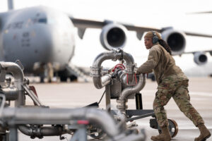 A U.S. Air Force Staff Sergeant of the 86th Logistic Readiness Squadron, packs up a pantograph fueling system after completing a refueling job at Ramstein Air Base, Germany, Jan. 31, 2024. The in-ground fuels system allowed Cash to pump the aircrafts nearly 32,000 gallon tank by herself, saving the 86th LRS from needing to send multiple fuel trucks and Airmen to accomplish the job. (U.S. Air Force photo by Senior Airman Andrew Bertain.)