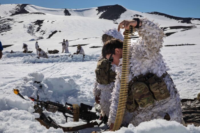 U.S. Army corporals, infantrymen with the 3rd Brigade Combat Team, 10th Mountain Division, load an M249 squad automatic weapon during Exercise Southern Vanguard 25, in Antuco, Chile, Aug. 26, 2025. Exercise Southern Vanguard 25 underscores the U.S. Army’s enduring commitment to regional partnership as U.S. forces deploy to Chile to conduct combined mountain warfare, field, and command post training alongside Chilean forces, with participation from Argentina and Peru - strengthening interoperability, shared readiness, and mutual trust while advancing regional security and cooperation across the Western Hemisphere. (U.S. Army National Guard photo by Sgt. Richelle Cruickshank.)