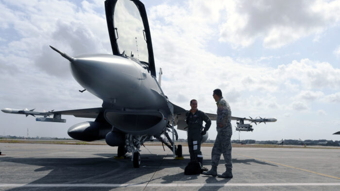 U.S. Air Force Maj and instructor pilot assigned to the 149th Fighter Wing, Texas Air National Guard, and Tech. Sgt. and crew chief with the 149 FW, share a laugh before takeoff Nov. 20 at Natal Air Force Base in Brazil during CRUZEX 2018. (U.S. Air National Guard photo by Tech. Sgt Mindy Bloem.)