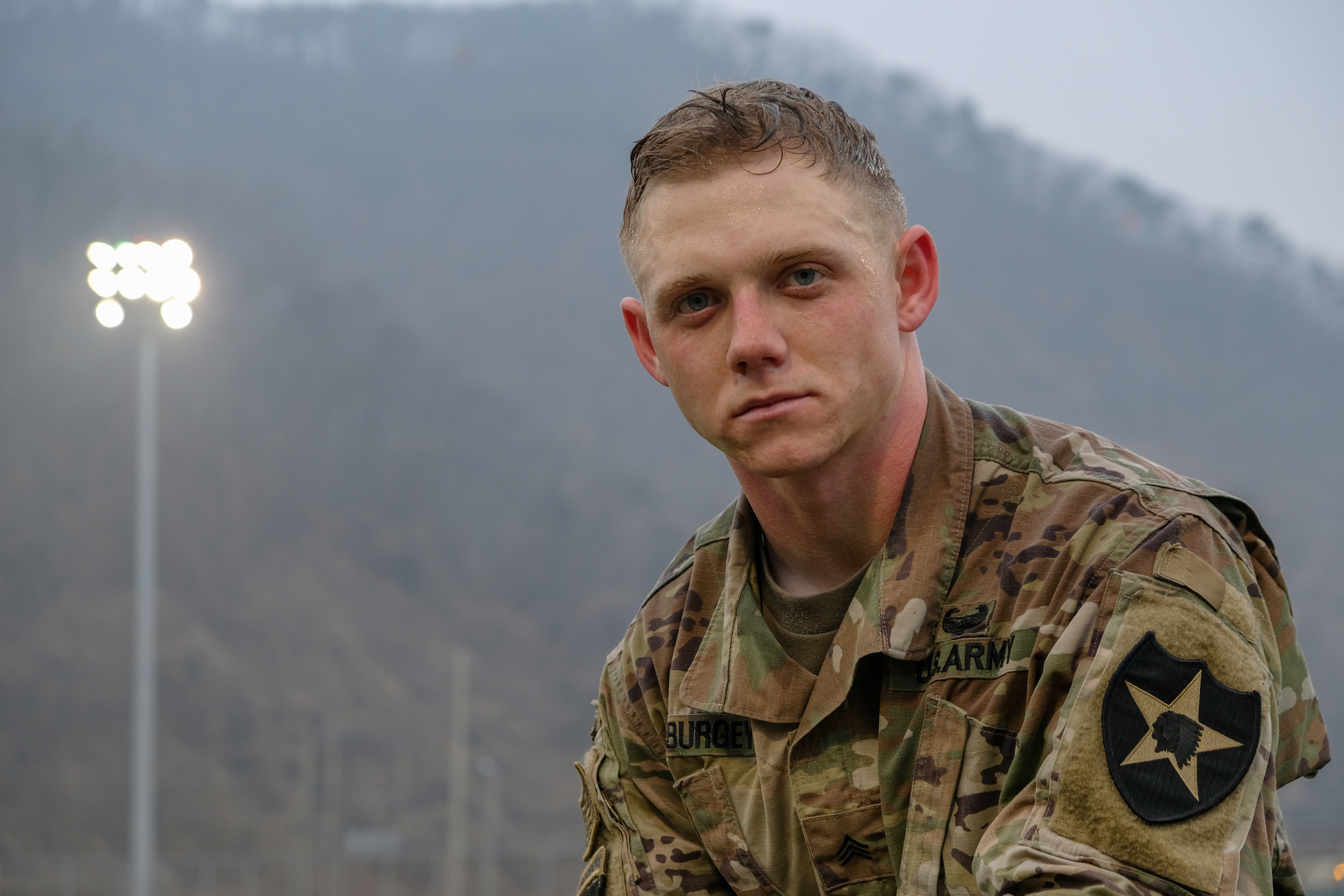 Army Sgt., fire control specialist, assigned to Battery A., 1st Battalion, 38th Field Artillery Regiment, 210th Field Artillery Brigade (FAB), pauses to pose for a quick photograph following the eight-mile ruck march during the 210th FAB 2019 Best Warrior Competition, Camp Casey, Republic of Korea, March 12, 2019. He was clearly exhausted but ready to keep moving through the events in the competition. The ruck march began this year’s competition with 24 Soldiers competing for first place in the following ranks: junior enlisted, noncommissioned officer, warrant officer, commissioned officer, and Korean Augmentation to the United States Army (KATUSA). The competition served as a valuable training experience, and the winners will advance to the 2nd Infantry Division Best Warrior Competition April 2019. (U.S. Army photo by Capt. Daniel Parker.)