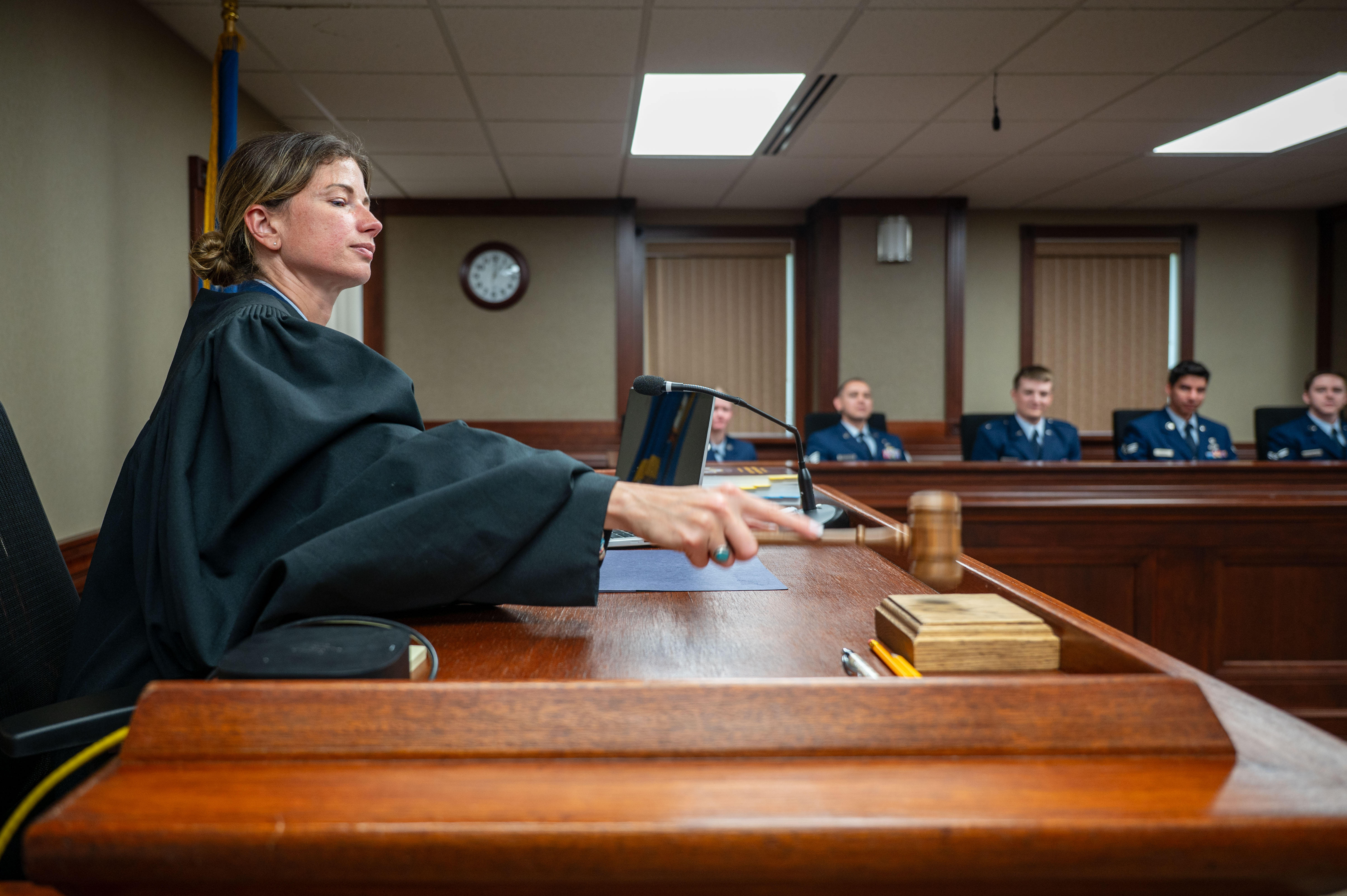 A 341st Missile Wing judge advocate strikes a gavel against a block July 3, 2025, at Malmstrom Air Force Base, Mont. Air Force judge advocates are commissioned officers who serve as military attorneys. (U.S. Air Force photo by Airman 1st Class Jack Rodriguez Escamilla.)