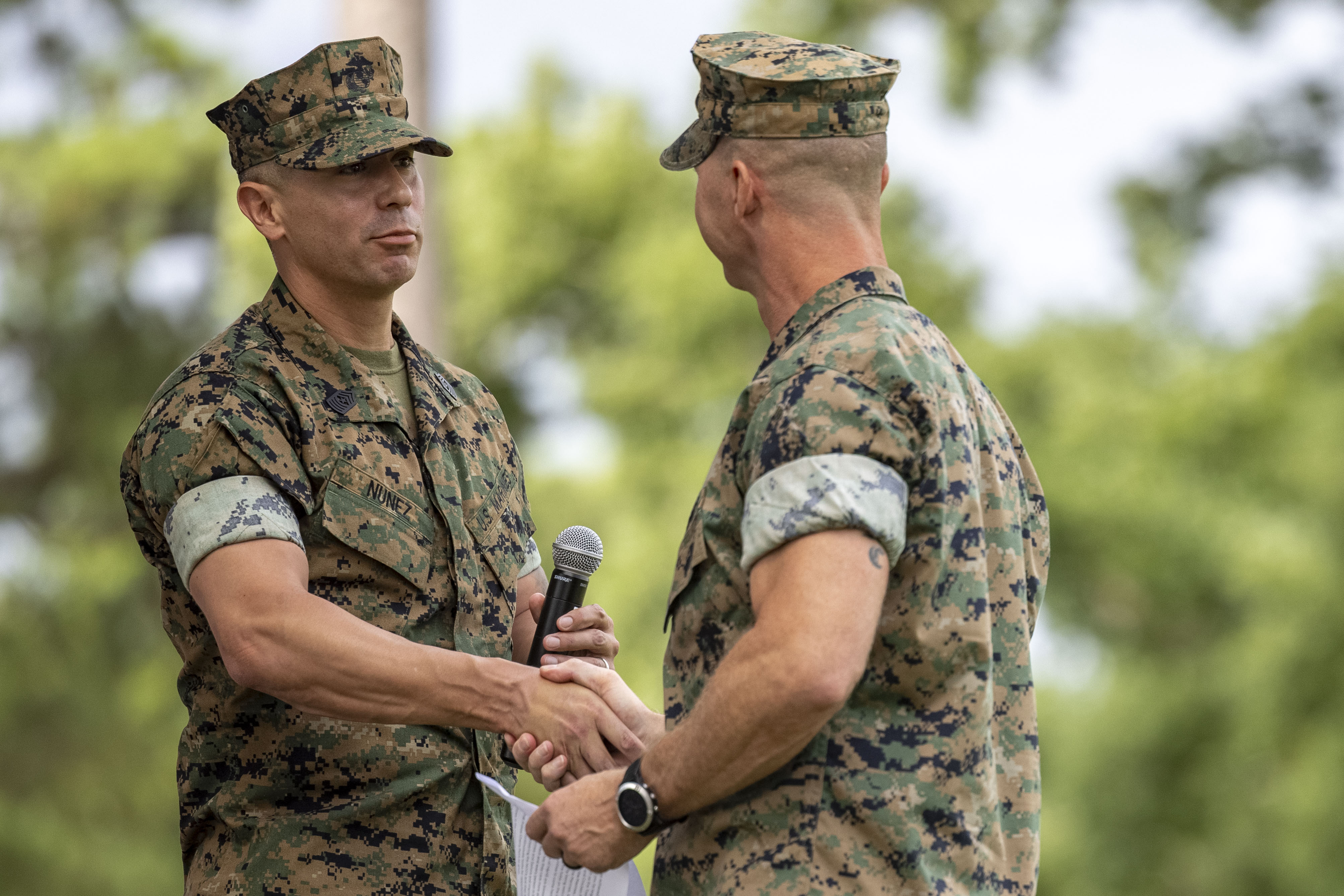 U.S. Marine Corps Sgt. Maj., left, oncoming command senior enlisted advisor, exchanges a handshake with Sgt. Maj., off going command senior enlisted advisor, both with Headquarters and Headquarters Squadron, Marine Corps Air Station Cherry Point, during a relief and appointment ceremony at MCAS Cherry Point, North Carolina, Aug. 6, 2025. The ceremony was held to honor a longstanding Marine Corps tradition that highlights the transfer of leadership and responsibilities from Burnette’s role as command senior enlisted advisor with H&HS, MCAS Cherry Point. (U.S. Marine Corps photo by Sgt. Samantha Rodriguez.)