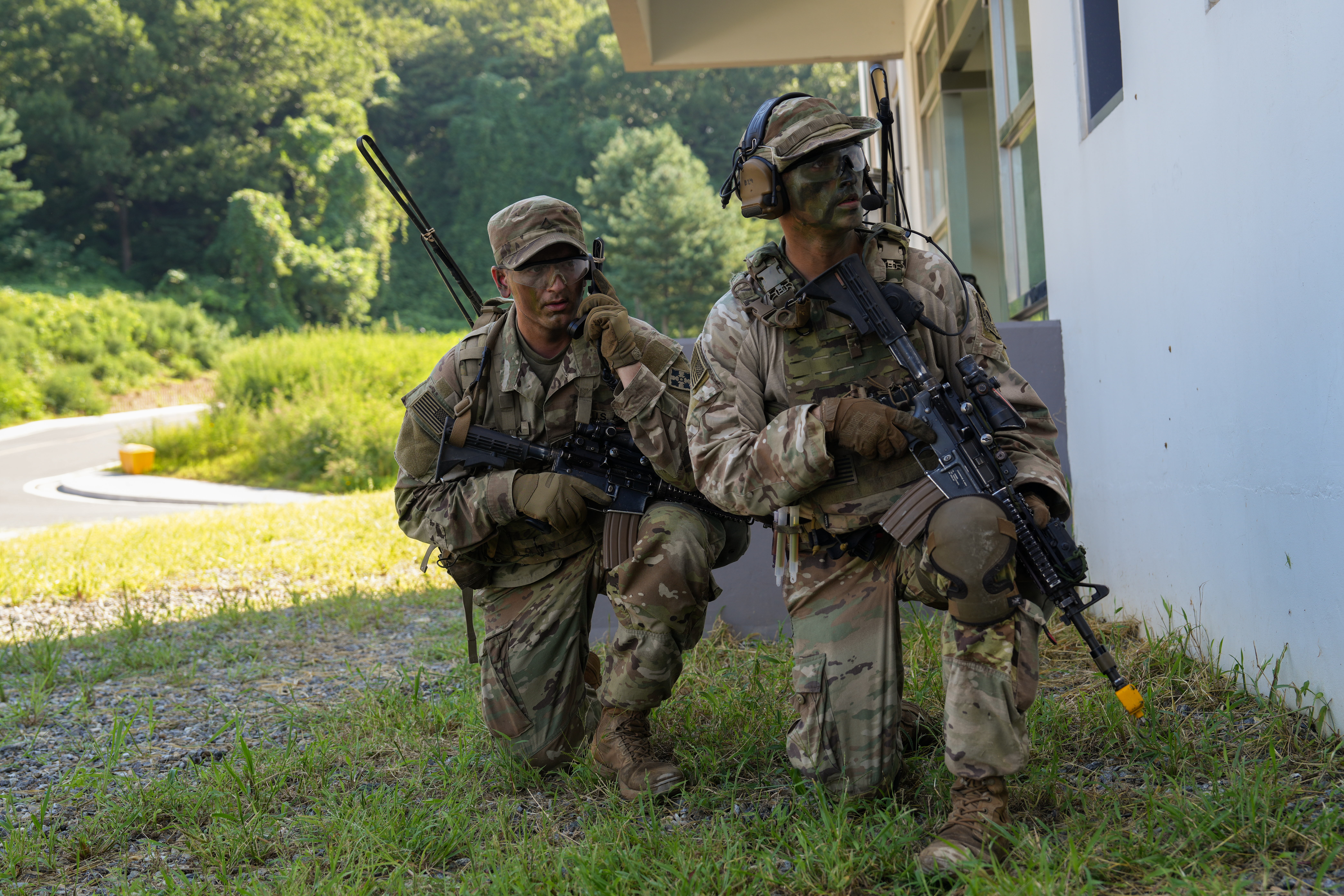 U.S. Army Soldiers assign to Company B, 4th Battalion, 9th Infantry Regiment, 1st Stryker Brigade Combat Team, 4th Infantry Division, await the order to advance during a military operation on urban terrain and counter weapons of mass destruction training as part of Ulchi Freedom Shield 25, Aug. 27, 2025, in South Korea. Ulchi Freedom Shield is an annual combined exercise conducted in support of the ROK-U.S. Mutual Defense Treaty signed in 1953. This combined exercise program highlights the ironclad commitment between the two nations to maintain a robust combined defense posture and to defend the people of the ROK from any threat. (U.S. Army photo by Sgt. Oniel McDonald.)