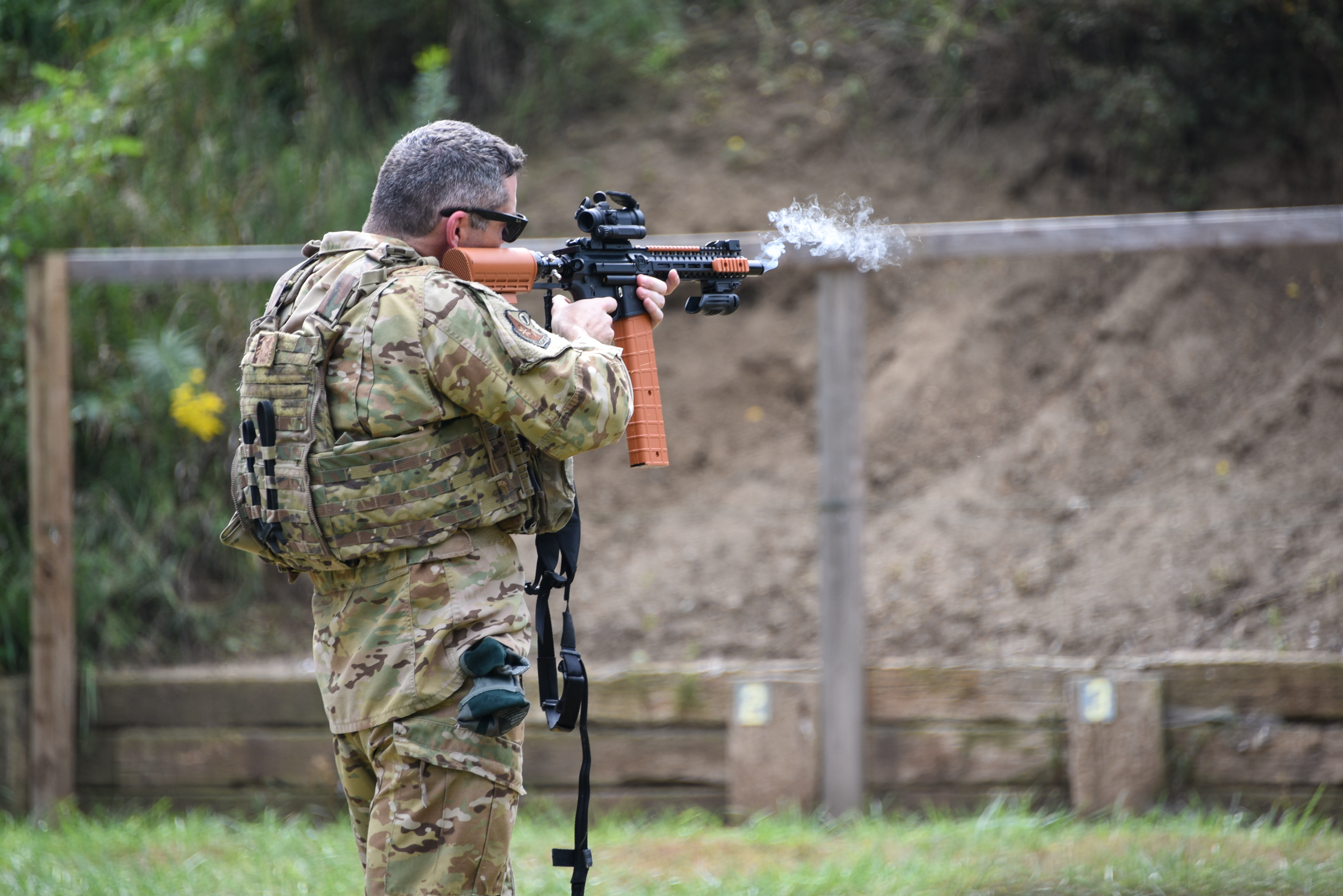 U.S. Air National Guard Col. and 185th Air Refueling Wing Commander aims a pepperball gun after shooting at the 185th ARW in Sioux City, Iowa, Sept. 14, 2025. Security Forces Airmen of the 185th practiced crowd control tactics with shields and pepper guns. (U.S. Air National Guard photo by Staff. Sgt. Olivia Monk.)