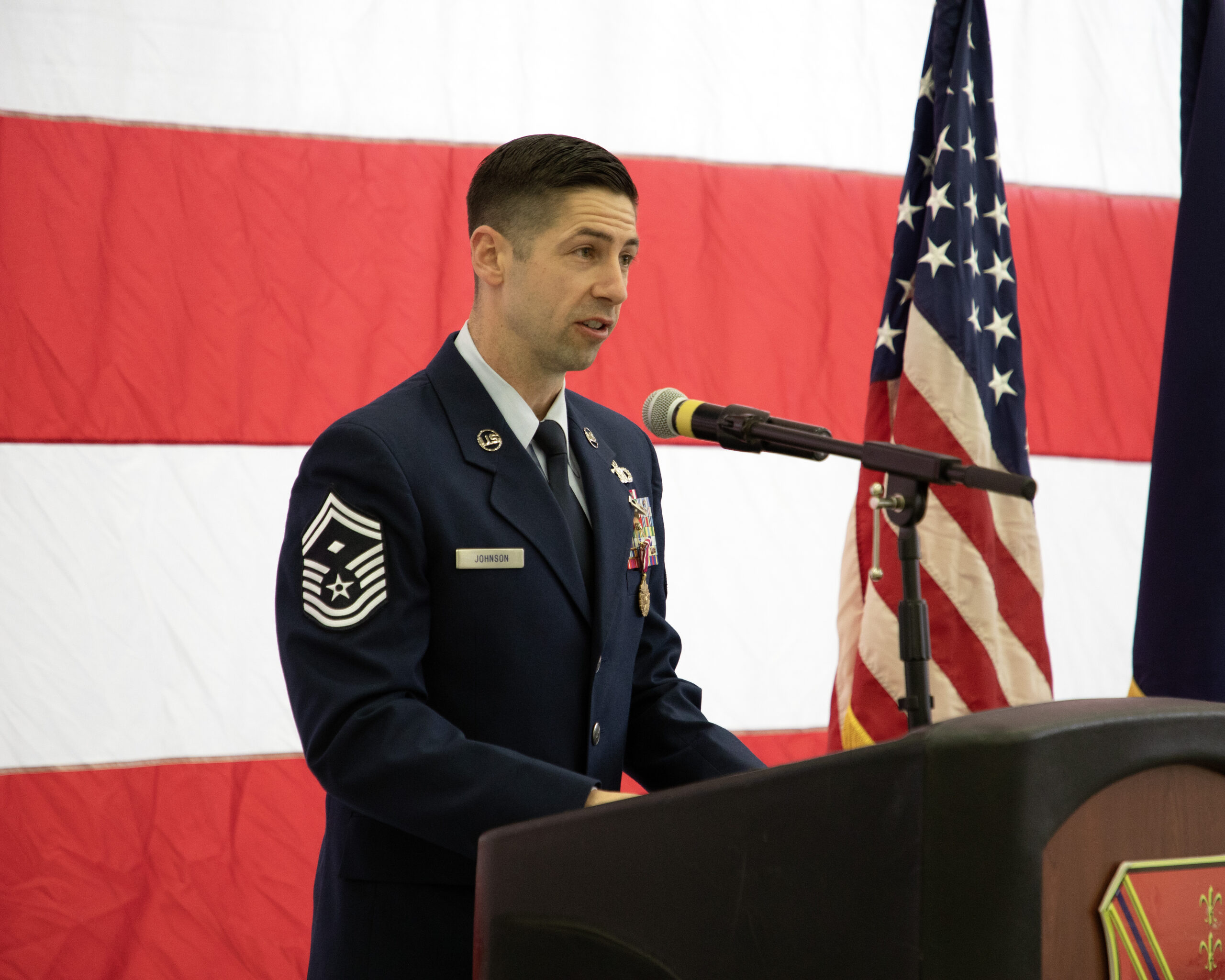 Senior Master Sgt. addresses Airmen of the 127th Wing, friends and family after being promoted to his current rank at Selfridge Air National Guard Base, Michigan, Dec. 6, 2025. He serves as the first sergeant of the headquarters section of the 127th Wing. (U.S. Air National Guard photo by Senior Master Sgt. Dan Heaton.)