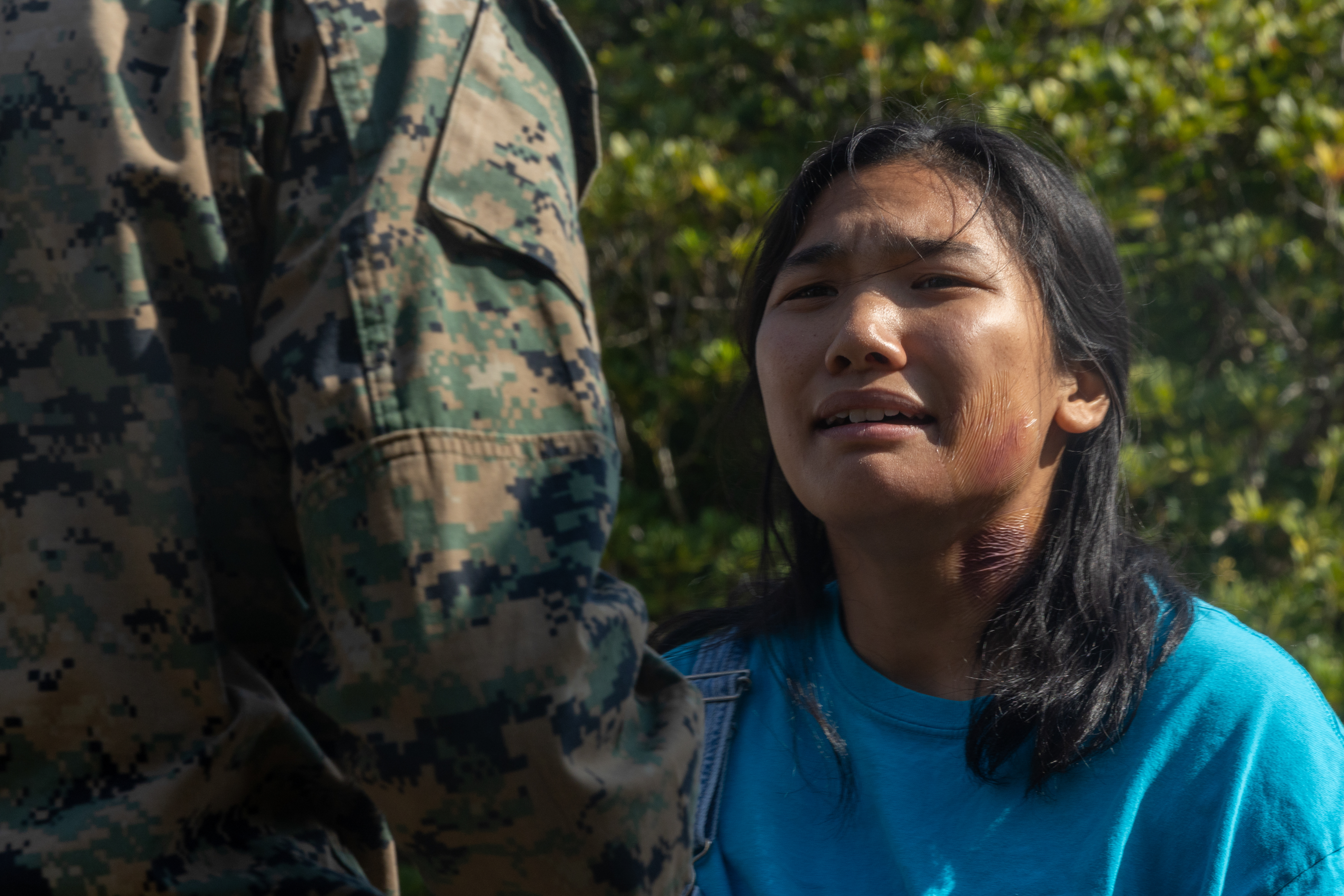 A U.S. Marine role-playing as a causality is processed through security during a noncombatant evacuation operation exercise on Camp Hansen, Okinawa, Japan, Dec. 18, 2025. A NEO is an evacuation of civilians and nonessential military personnel from volatile situations overseas to designated safe havens. The 31st MEU, the Marine Corps’ only continuously forward-deployed MEU, provides a flexible and lethal force ready to perform a wide range of military operations as the premiere crisis response force in the Indo-Pacific region. (U.S. Marine Corps photo by Cpl. Maksim Masloboev.)