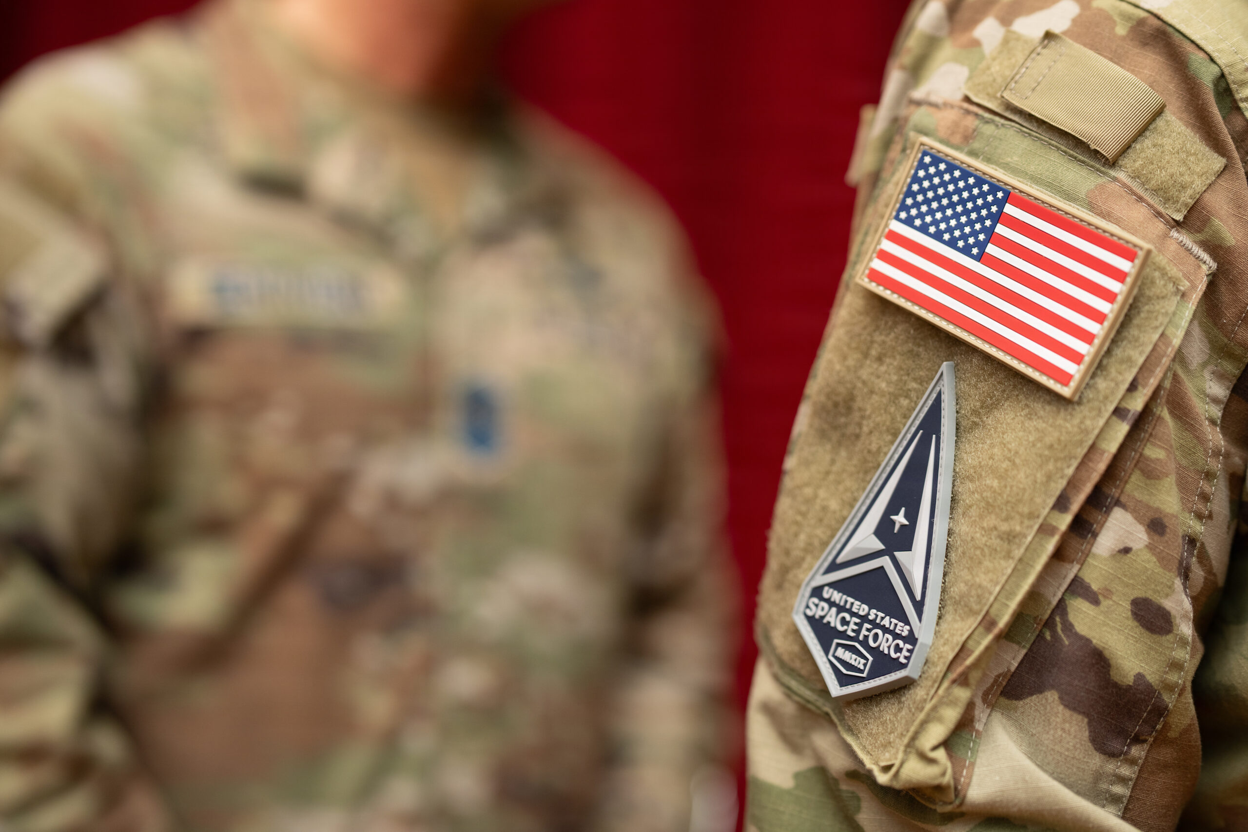 A new U.S. Space Force patch sits on the uniform of U.S. Space Force Specialist, a graduating Guardian, during a Basic Military Training patching ceremony at Bob Hope Theater, Joint Base San Antonio-Lackland, Texas, Feb. 17, 2026. The patching ceremony is the first graduation event and symbolizes the transition from trainee to Guardian, connecting the new Guardians to their service’s core values and their mission to dominate the space domain and secure our nation's future. (U.S. Air Force photo by Jonathan R. Mallard.)